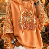 Laura | Halloween-inspirierter Kapuzenpullover mit orangefarbener Schleife und Kürbismuster und Dreiviertelärmeln